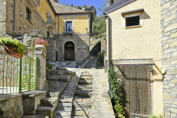 A narrow street among the old houses of Castelmezzano, a rural village in the Basilicata region, Italy.