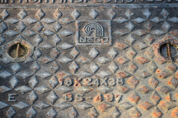 Metal lid on a walkway