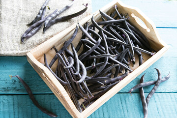 Protein-rich string beans lie on a wooden tray. The concept of healthy eating.Horizontal orientation