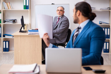 Two male colleagues working in the office