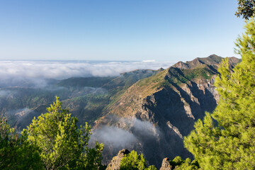 Views of the Sierra Almijara, Tejeda and Alhama from the viewpoint of the highway of the goat, with low clouds that cover the tops of the mountains, creating a panoramic view of a sea of clouds.