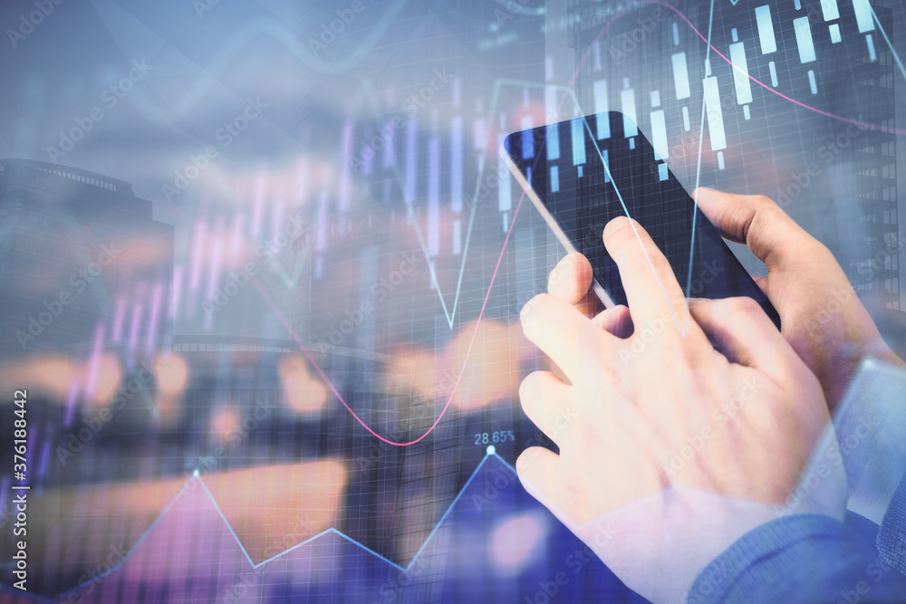 Poster double exposure of man's hands holding and using a digital device and forex graph drawing. financial