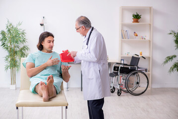 Fototapeta premium Young male patient visiting experienced doctor gastroenterologist