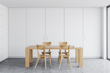 Wooden table in white dining room