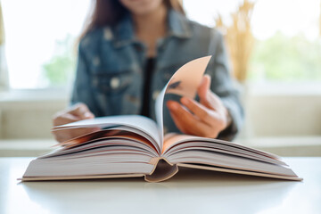 Closeup image of a woman sitting and reading book