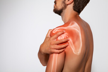 Shoulder scapula pain, man holding a hand on a painful zone