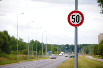 speed limit sign and road on background