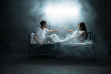 Crazy man and woman are sitting in bed, insomnia