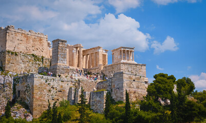 Fototapeta na wymiar View of Acropolis hill from Areopagus hill in summer day with great clouds in blue sky, Athens, Greece. UNESCO heritage. Propylaea gate, Parthenon.