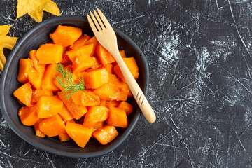 Thanksgiving roasted pumpkin. Harvesting, autumn. Dark background, flat lay, copy space