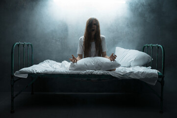 Psycho woman screams in bed, insomnia horror