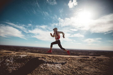 Fototapeta na wymiar Fitness woman trail runner cross country running on sand desert dunes