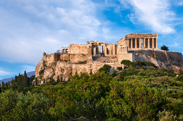 Great view of Acropolis hill from Pnyx hill on summer day with great clouds in blue sky, Athens, Greece. UNESCO world heritage. Propylaea, Parthenon.