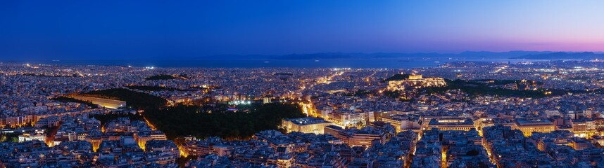 Panorama of Athens and Saronic Gulf from Lycabettus hill at dusk. Acropolis, Parthenon, Hellenic Parliament, Syntagma, Olympic stadium of Kallimarmaro.