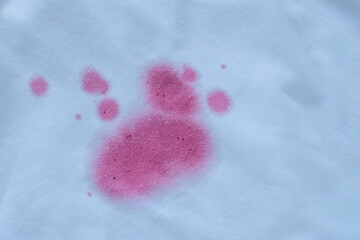 dirty pink stain on clothes. The concept of cleaning stains on clothes. Means of cleaning stains.