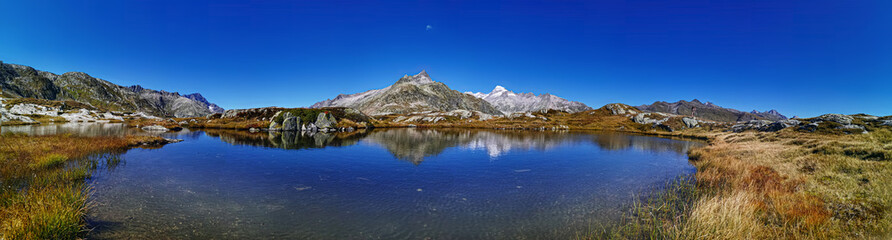 panorama scenery of the swiss alps. Lake at the top of grimsel p