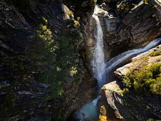 water fall shot from above. Stream running over rocky cliff in S