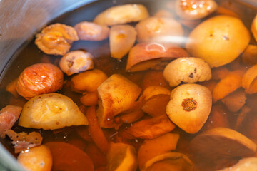 Stewed apples, peaches and plums are cooked in a pan