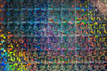 macro photo of silver rainbow holographic foil material, colorful hologram surface, triangular...