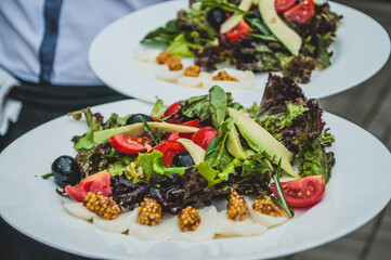 Serving the salad. Fine cuisine in a restaurant
