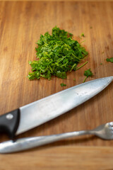 fresh, green, chopped parsley on a kitchen table board