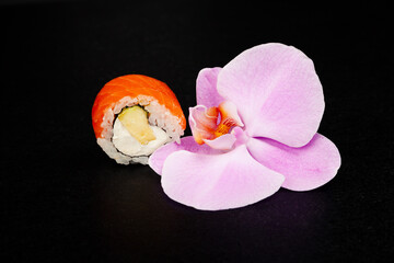 Sushi roll Philadelphia with avocado decorated with herbs on a plate, classic Japanese sushi. Traditional Japanese food with maki. Delicious pieces of sushi. For the restaurant menu. copyspace.