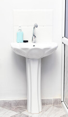 soap bottle over sink in bathroom.