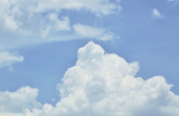Naklejka na ściany i meble Big clouds spreading on sky in sunny day