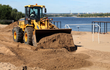 excavator at work on the sand beach