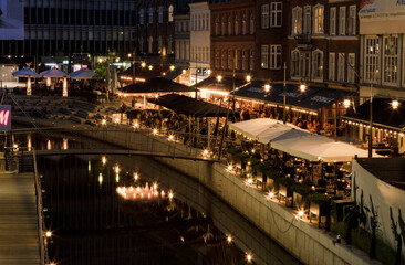 River in Aarhus with café at night time, evening. Boardwalk in Århus.