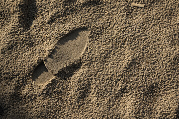 Shoe footprint in sand.