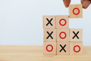 tic tac toe concept. leader business man try flip wooden cube to speed win the game of  OX for fast winning  by using strategy to make opportunity success . copy space