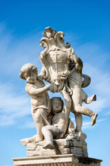 Fototapeta na wymiar Putti fountain (Fontana dei Putti), Square of Miracles (Piazza dei Miracoli), Pisa, Tuscany, Italy. Three marble cherubs support the coat of arms of the city. Sculptor, Giovanni Antonio Cybei