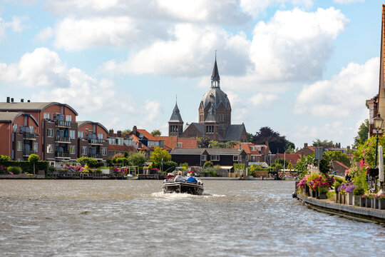 A sloop sails over the old Rijn near the South-Holland village of Leiderdorp in the Netherlands.