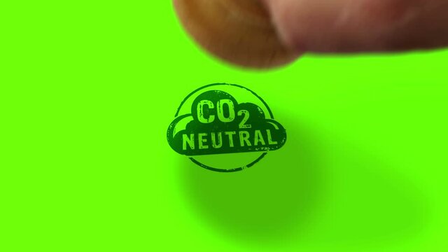 CO2 carbon neutral emission stamp and hand stamping impact isolated animation. Ecology, nature friendly, climate change, green fuel and earth protect 3D rendered concept. Alpha matte channel.