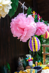 Tropical party decorations. Colorful paper pom poms, tropical themed party. Garden party. 