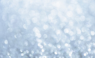 White glitter vintage lights background. Bokeh silver and white. de-focused copy space.