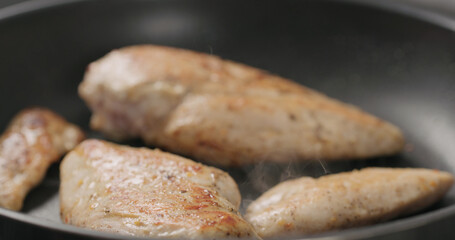 chicken fillet frying on non-stick pan