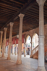 
pavilion of the Venice fish market consisting of a stone colonnade supporting wooden floors