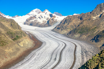 Great Aletsch Glacier, the largest glacier in the Alps and UNESCO heritage from Eggishorn viewpoint, 2869 m above sea level in Canton of Valais, Switzerland, Europe. Summer season, clear blue sky.