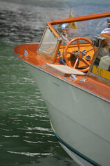 
bow of a motorboat used as a taxi as indicated by the side writing on a yellow sign