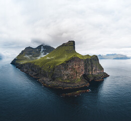 Aerial Drone view of Kalsoy islands on Faroe islands. Aerial panorama of a small white lighthouse...