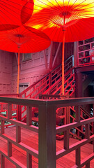 Fototapeta na wymiar Low angle view of red parasols in sunlight