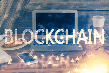 Double exposure of blockchain theme hologram and table with computer background. Concept of bitcoin...