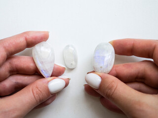 Pendant made of natural moonstone in a woman's hand