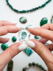 Pendant made of natural rock crystal in a woman's hand
