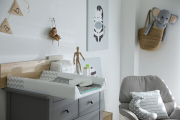 Modern changing table in baby room interior