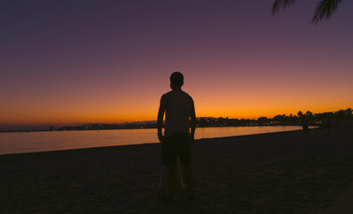 silhouette of a young man in the beach of Roses