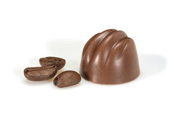 Chocolate pralines and coffee beans. Dark chocolate bonbon with coffee souffle, macro close up isolated on white background.