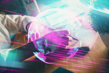 Tech theme hologram over woman's hands taking notes background. Concept of hightech. Double exposure